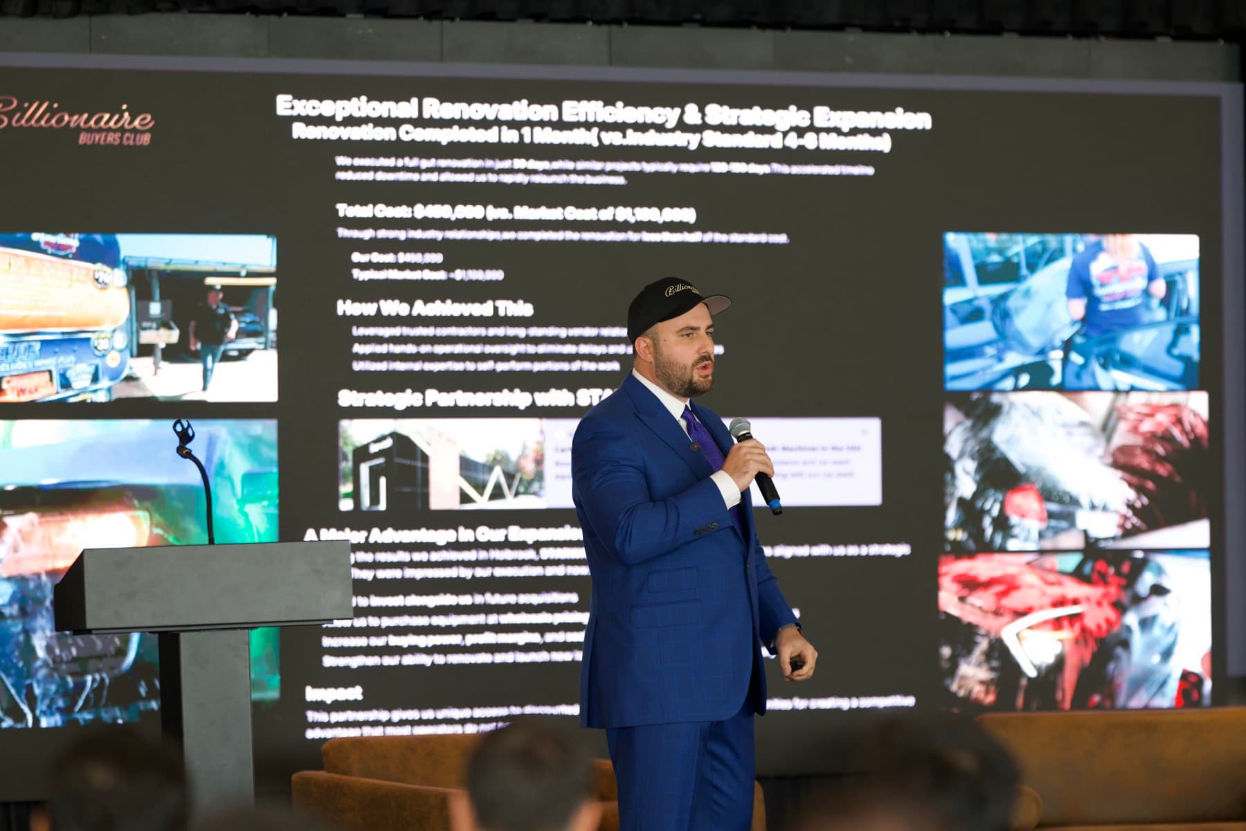 Mike Steinberg breaking down a live deal at the previous Billionaire Buyers Club event, with the Hedgestone deal-breakdown slide visible on the screen behind him.