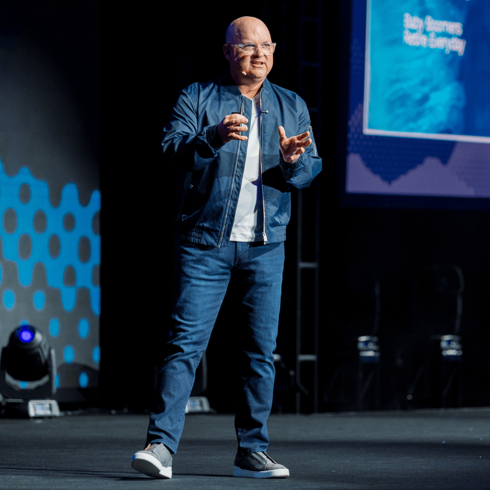 Vic Keller speaking on stage.